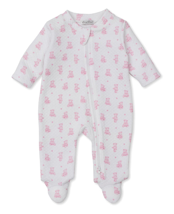 A baby footie with a pink teddy bear pattern and asymmetrical zipper closure.