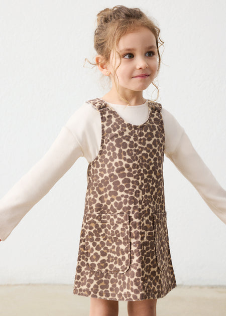 A two-piece dress set with a leopard print pattern, displayed on a young girl.