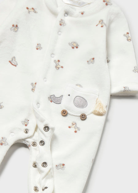 footie set with vintage toy print on cream fabric, featuring an elephant pocket detail and snap button closure.