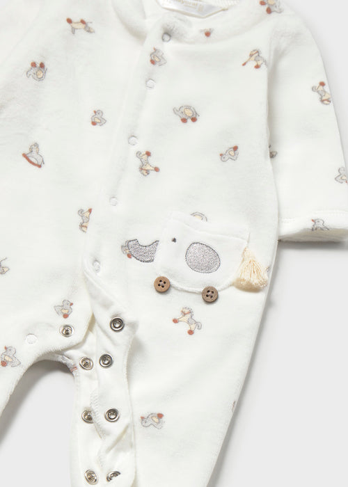 footie set with vintage toy print on cream fabric, featuring an elephant pocket detail and snap button closure.