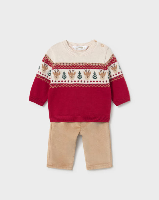 Infant red and cream sweater with reindeer pattern and beige corduroy pants.