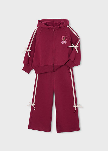 Maroon sweatsuit with cherry embroidery and bow details, featuring a front zip and relaxed fit.