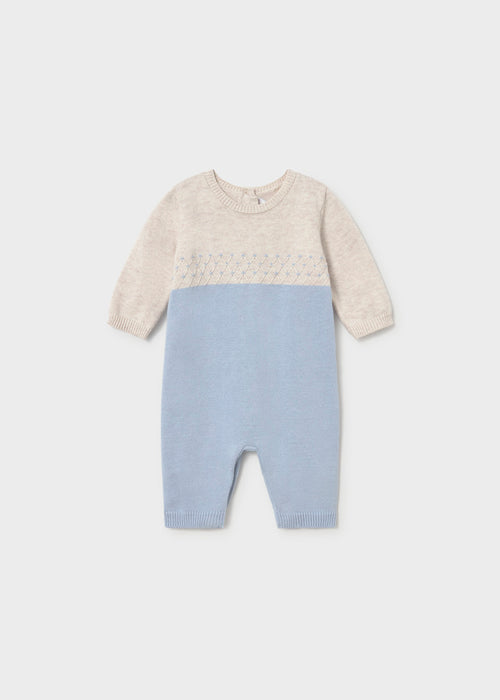 A blue and beige knit baby romper with long sleeves and a round neckline.