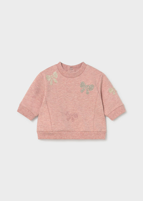 Pink sweatshirt with bow accents and denim pants set for infants.