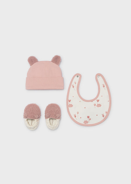 Pink bear-themed baby gift set with a hat, bib, and slippers.