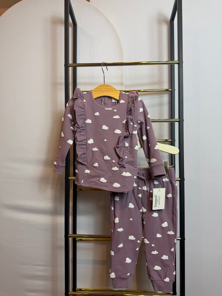 A lavender two-piece set with white cloud print, featuring a long sleeve top with ruffles and jogger pants.