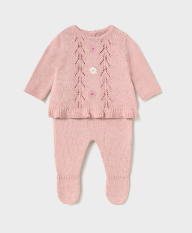 A soft pink knit set featuring a long-sleeve top with flower patterns and matching footed pants.