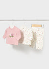 Three-piece infant set with a pink top featuring a flower applique, a white floral jacket, and matching pants.