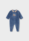 A navy velour footie with a plaid collar and an embroidered train design on the front.
