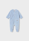A blue velour footie with a cloud pattern, featuring a snap front and two front pockets.