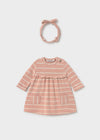 Pink and beige striped dress with matching headband, displayed on a flat surface.
