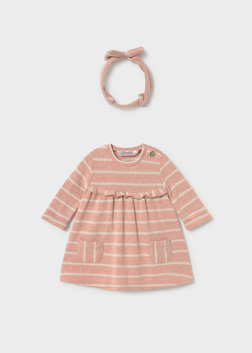 Pink and beige striped dress with matching headband, displayed on a flat surface.