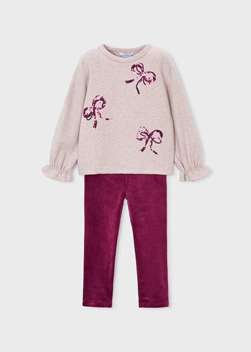 Toddler outfit with beige bow-embellished top and raspberry velour leggings.