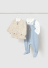 Blue footie overall with a star motif and a beige jacket on a hanger.